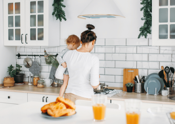 Mom and child in kitchen making breakfast